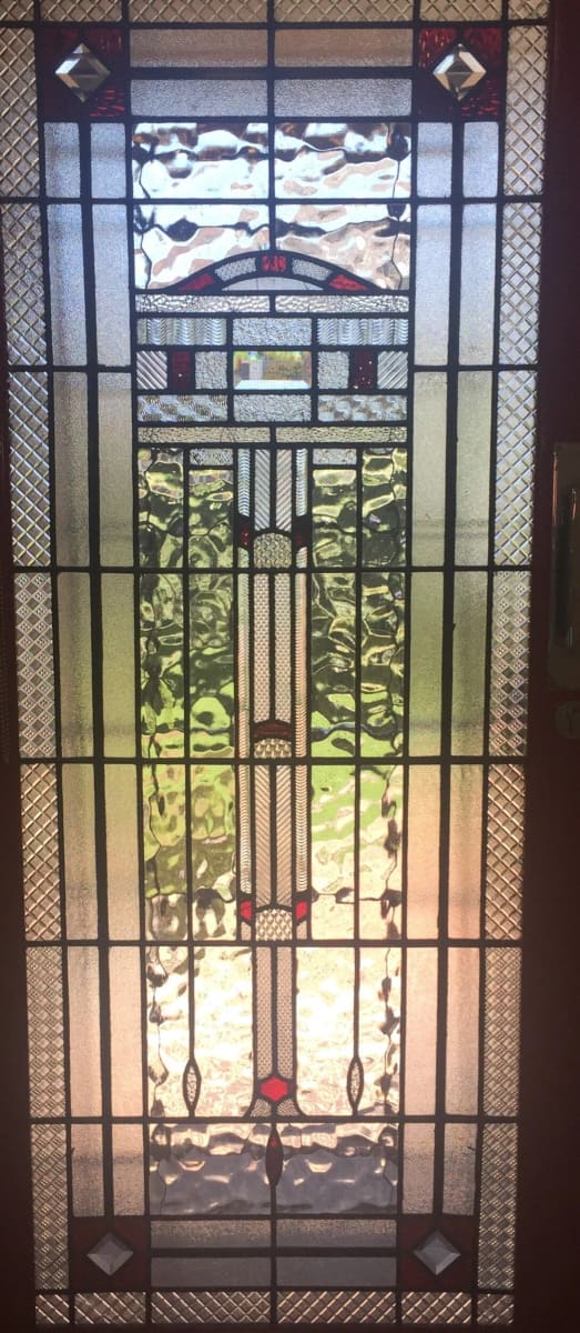 Tall Art Deco door panel with a stepped fountain motif in textured and amber glass