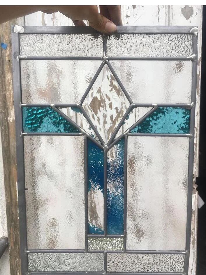 Art Deco panel with a stepped teal diamond motif on a rippled clear-glass ground
