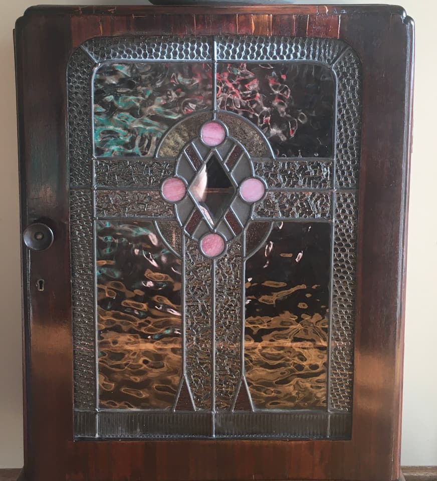 Ornate Art Deco door medallion panel with dramatic rippled reflections