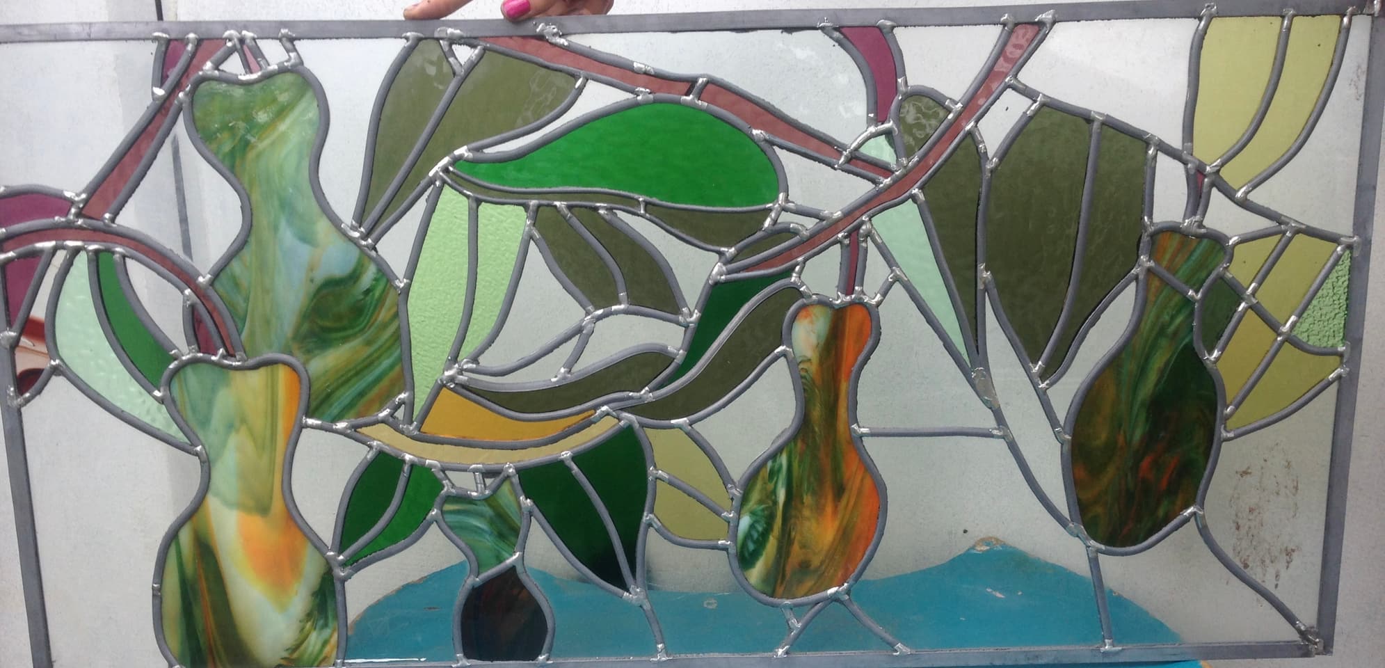 Wide gum-leaf and gumnut panel in leadlight, finished in warm amber and green tones