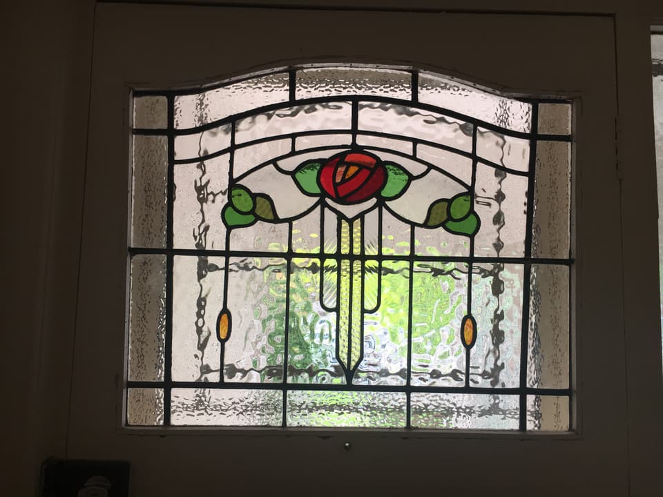 Federation arched fanlight with a central rose in a white frame
