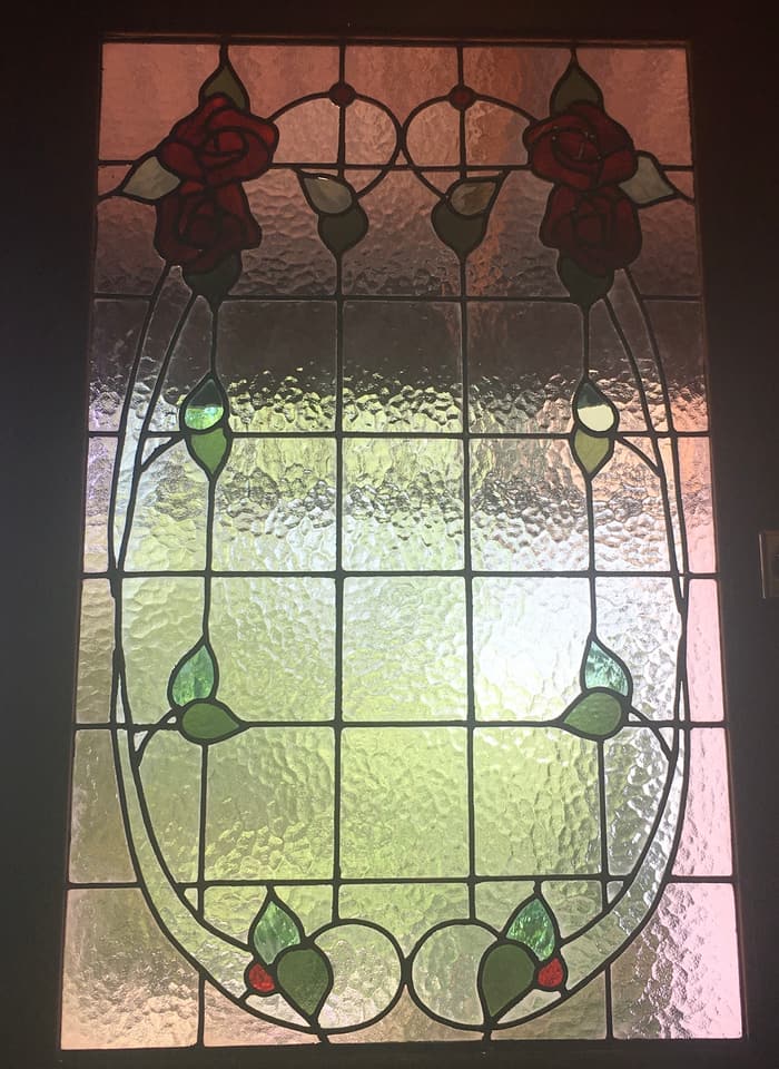 Federation rose panel in an oval-framed rectangular leadlight