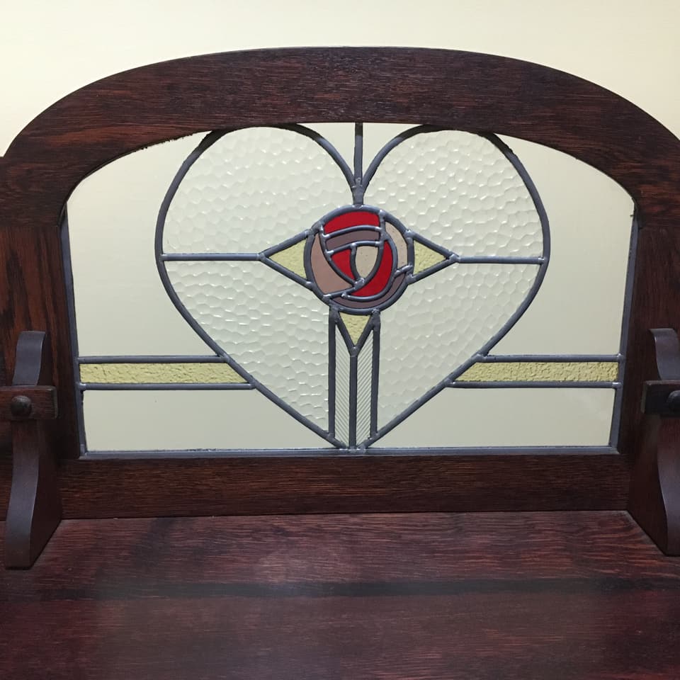 A heart-shaped custom leadlight panel set into a timber bench back