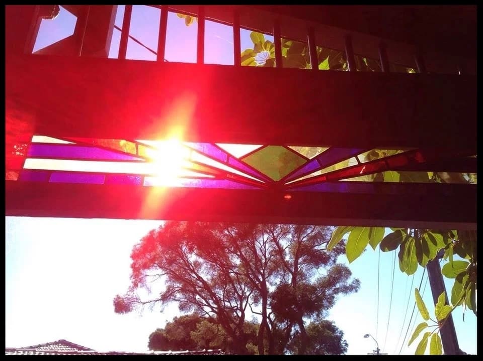 Federation sunburst fanlight shot from below with the sun flaring through its amber rays